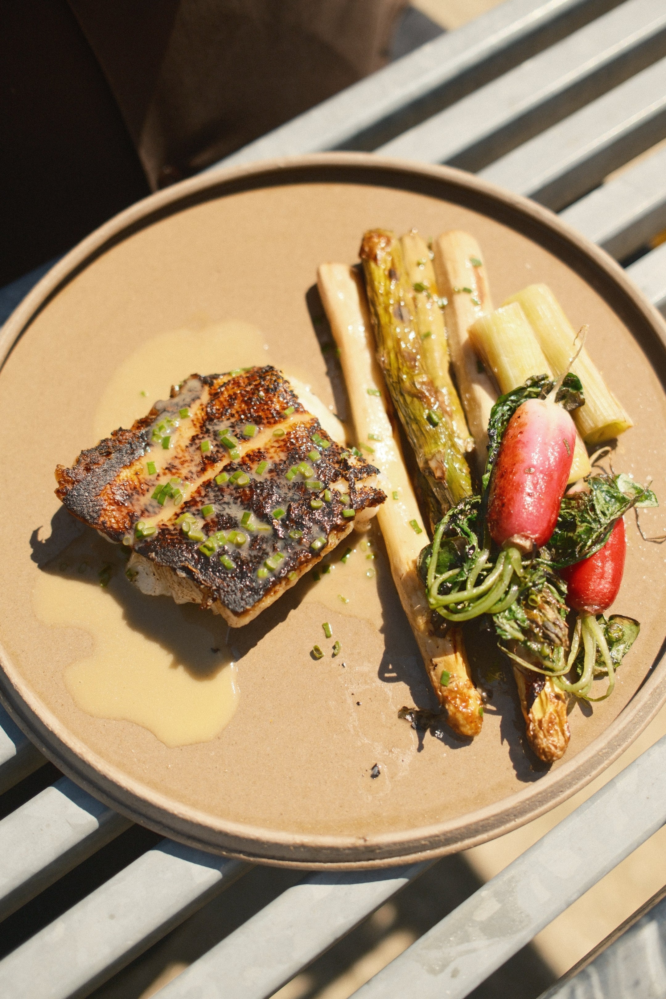 Seared cod fillet with grilled green and white asparagus and beurre blanc