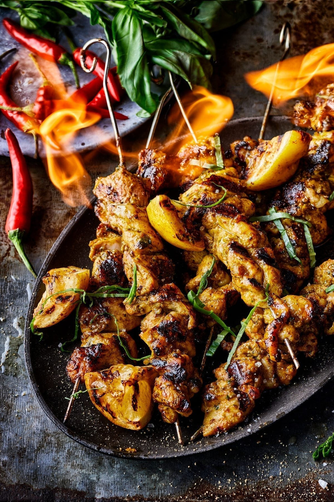 Peri peri chicken skewers charring over direct heat on a Bastard kamado