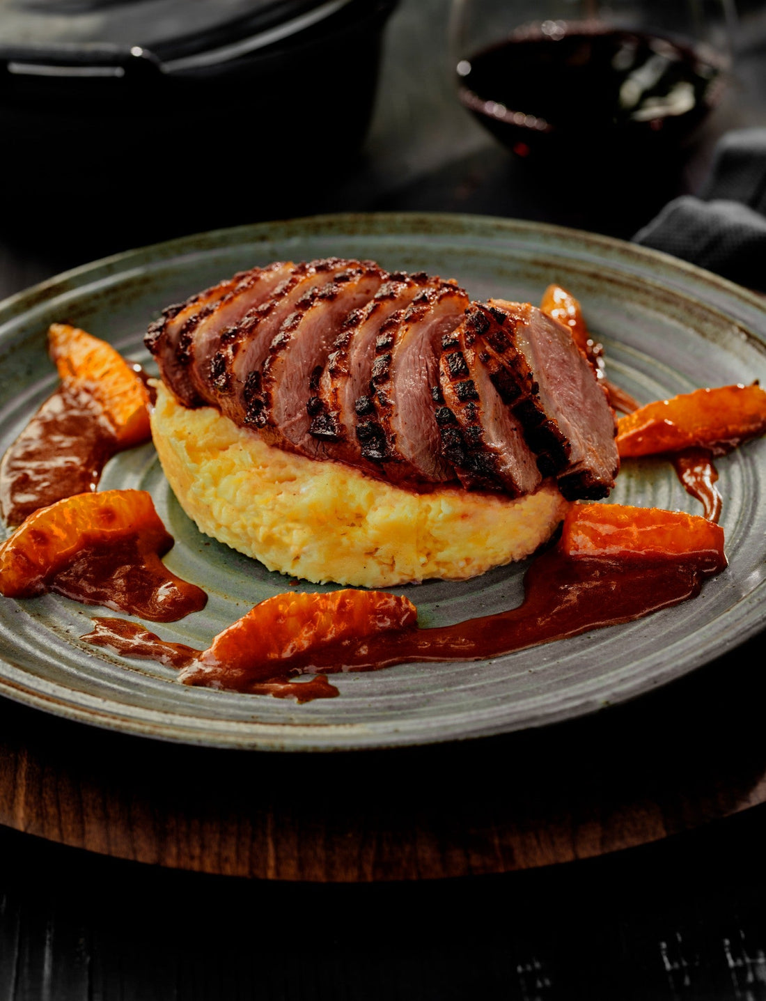Sliced duck breast on parsnip mash with caramelised orange segments and orange sauce