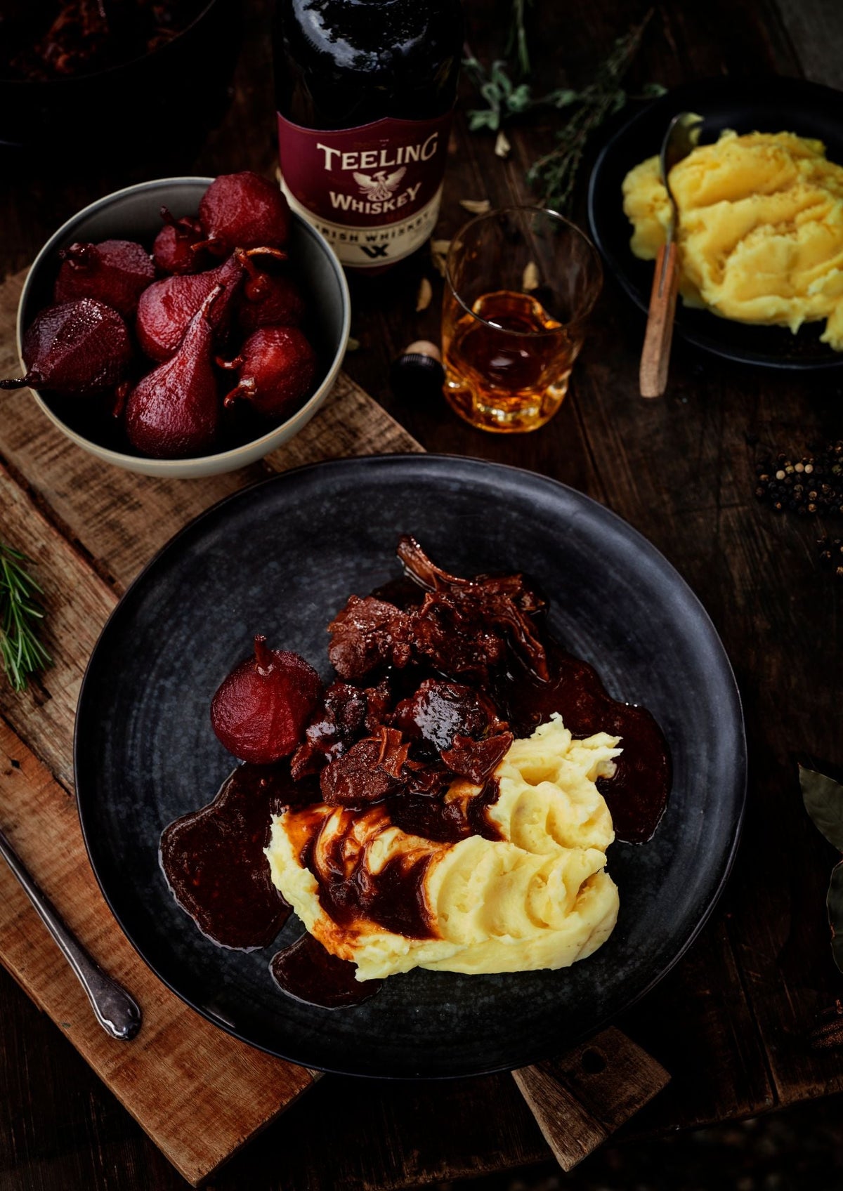 Slow-braised game stew with mashed potatoes and red wine poached pears